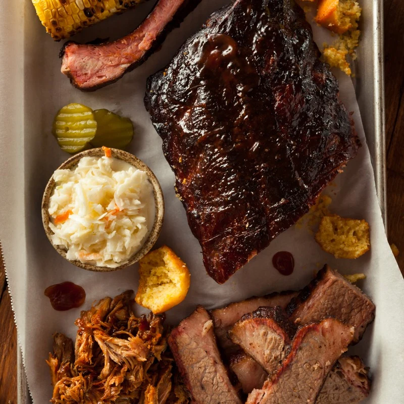 Barbecue ribs, brisket and sides on a shared platter.
